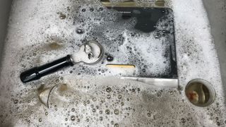 Parts of the casabrews 5700 pro in a soapy sink