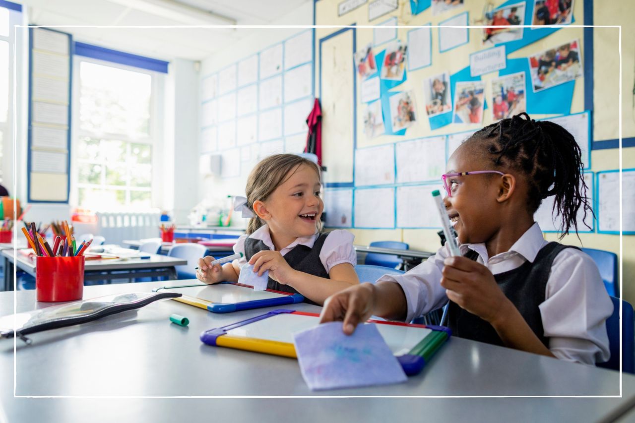 school children sat in classroom laughing