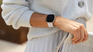 Elegant woman wearing the Fitbit Sense smartwarch