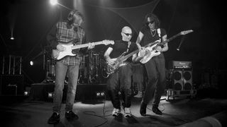 Guitarists Eric Johnson, Joe Satriani and Steve Vai are shown performing on stage during a a "live" concert appearance with G3 on August 1, 1996.