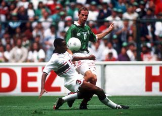 Mexico's Luis Roberto Alves competes for the ball with the USA's George Pope in a World Cup qualification match in 1997.