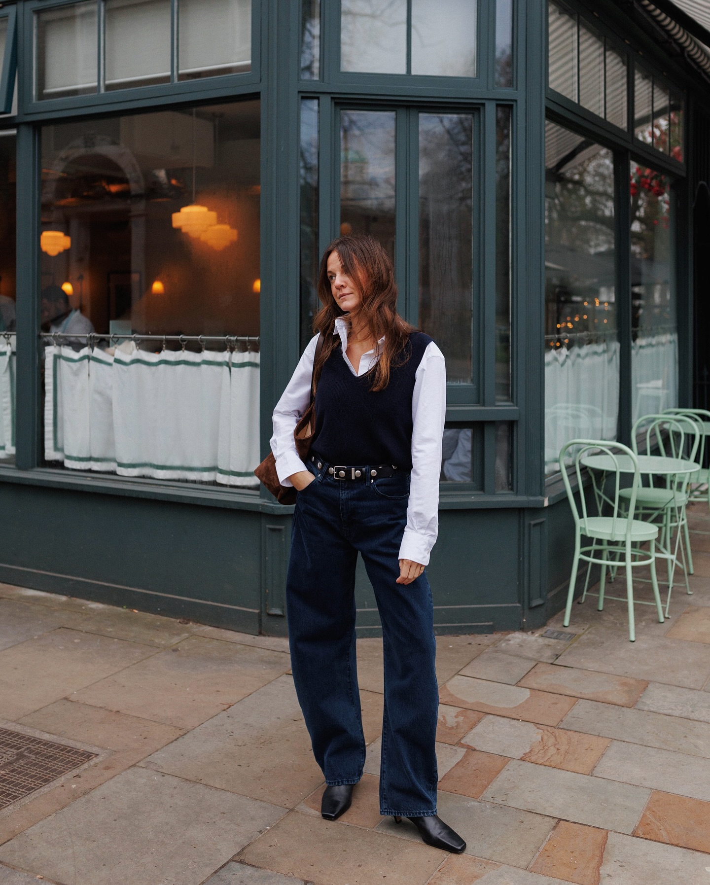 Kim in dark wash jeans and boots