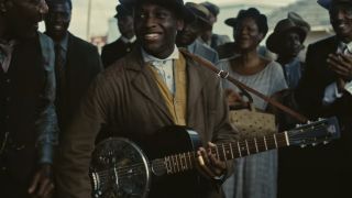 Miles Caton holding a guitar in Sinners