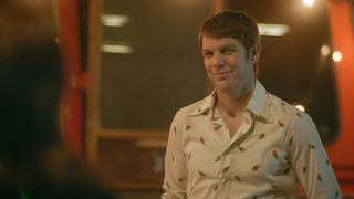 Jake Lacy as Robert "B" Berchtold smiling in A Friend of the Family