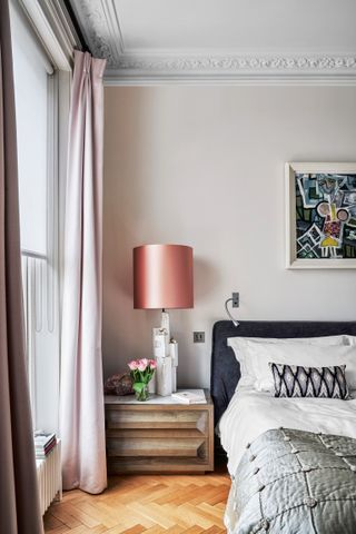 Pale grey bedroom with pink curtains and lampshade
