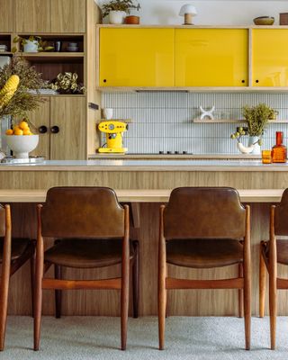 A kitchen with bright yellow coffee machine