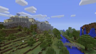 A Minecraft world. Mostly plains and green tree areas. A castle sits atop a hill with the Scottish flag on it