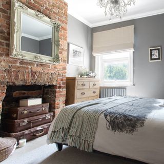 Grey bedroom with exposed brick feature wall