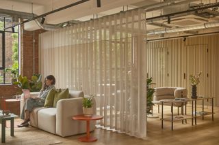 the loom club interiors with timber cladding and soft curtains dividing the space