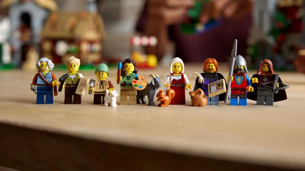 The minifigures from Lego Medieval Town Square, lined up on a wooden table