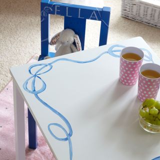 kids tea table with blue chair and carpet flooring