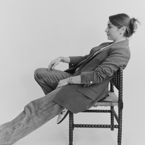 Profile black and white image of a woman sitting in a bobbin chair