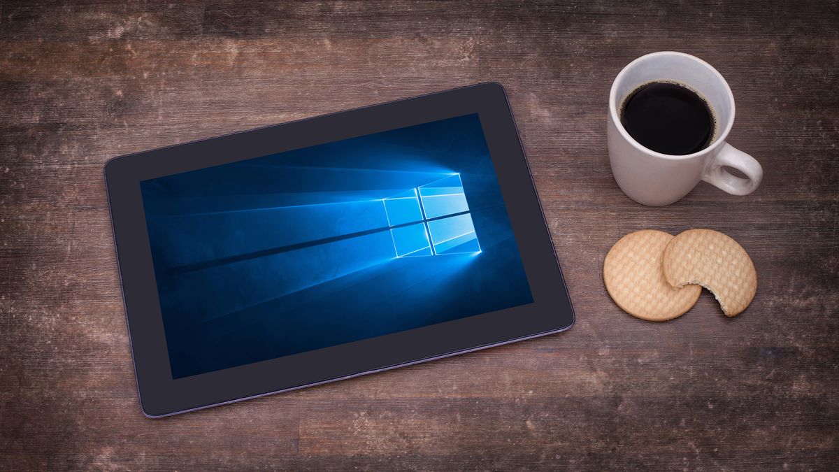 A tablet on a table showing the Windows 10 logo