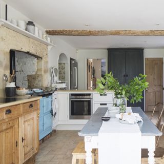 kitchen in restored farmhouse with pale blue Aga