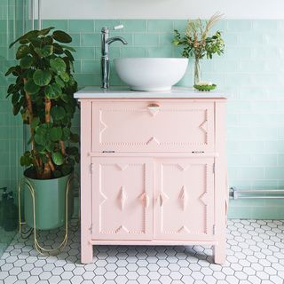 bathroom with pink painted cabinet