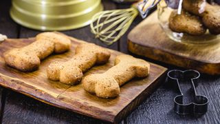 Baked dog biscuits resting on a board