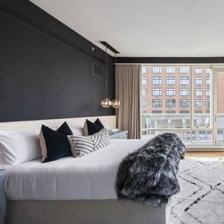 dark walled bedroom with wooden flooring and carpet