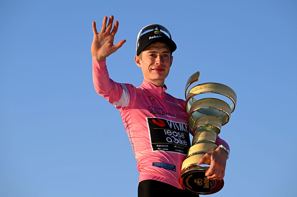 Jonas Vingegaard of Denmark and Team Visma | Lease a Bike celebrates at podium as Pink Leader Jersey and overall race winner