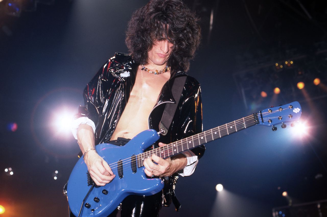 Joe Perry performs onstage with Aerosmith at the Joe Louis Arena in Detroit, Michigan on December 5, 1987