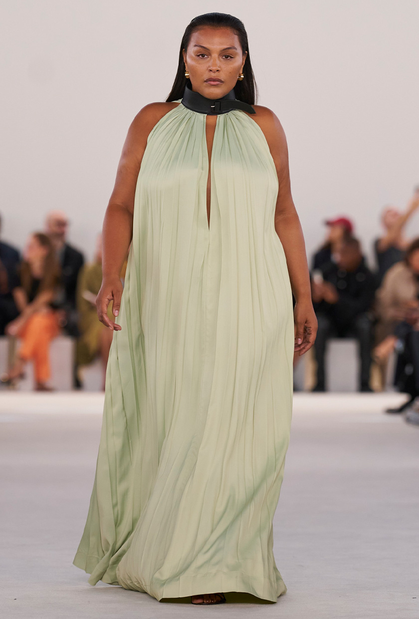 halter dress trend on the Ferragamo spring 2024 runway with a model wearing a pistachio green maxi dress and gold earrings
