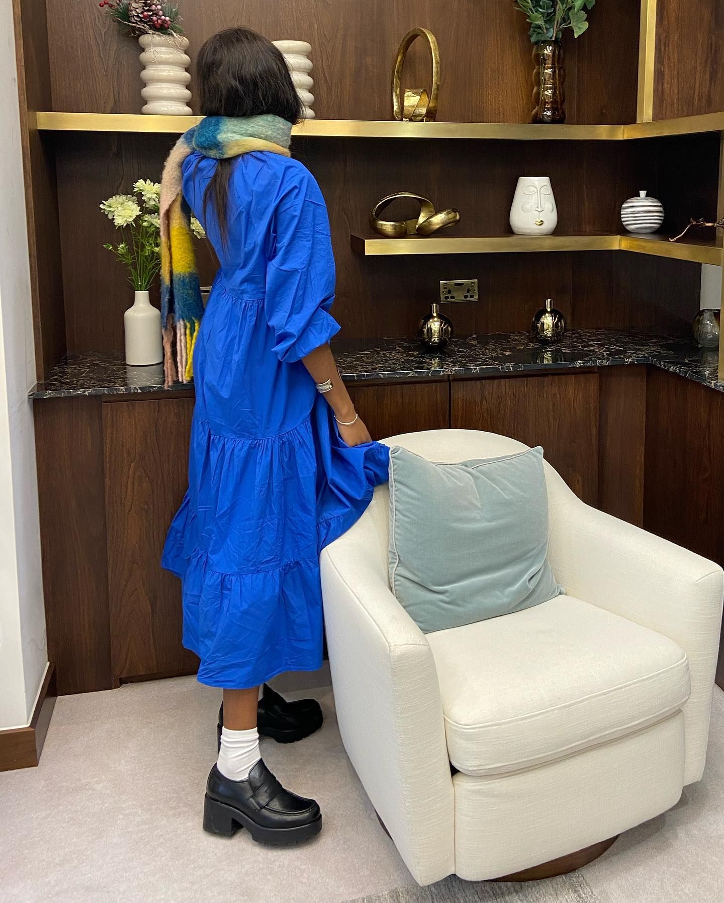 Influencer wears heeled loafers.
