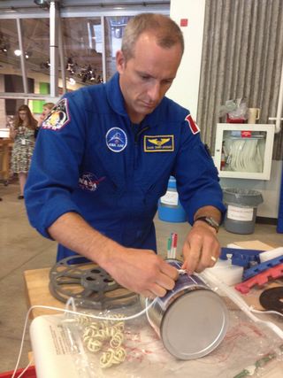 Canadian astronaut David Saint-Jacques puts together a rudimentary Mars lander at the Ontario Science Centre. Saint-Jacques was participating in an astronaut race in Toronto, Sept. 30, 2014.