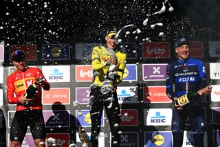 WAREGEM BELGIUM MARCH 27 LR Jonas Abrahamsen of Norway and Team UnoX Mobility on second place race winner Matteo Jorgenson of The United States and Team Visma Lease a Bike and Stefan Kung of Switzerland and Team Groupama FDJ on third place pose and celebrate with champagne on the podium ceremony after the 78th Dwars Door Vlaanderen 2024 Mens Elite a 1886km one day race from Roeselare to Waregem UCIWT on March 27 2024 in Waregem Belgium Photo by Tim de WaeleGetty Images