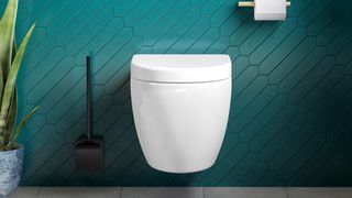 white wall hung toilet with green wall tiles
