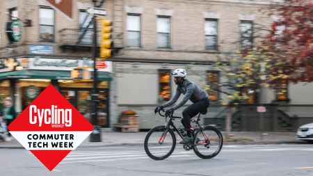 Man cycling to work through the city streets dressed in cycling jackets and bib tights