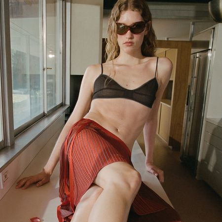 A model poses for summer's Mango x Eckhaus Latta collaboration 