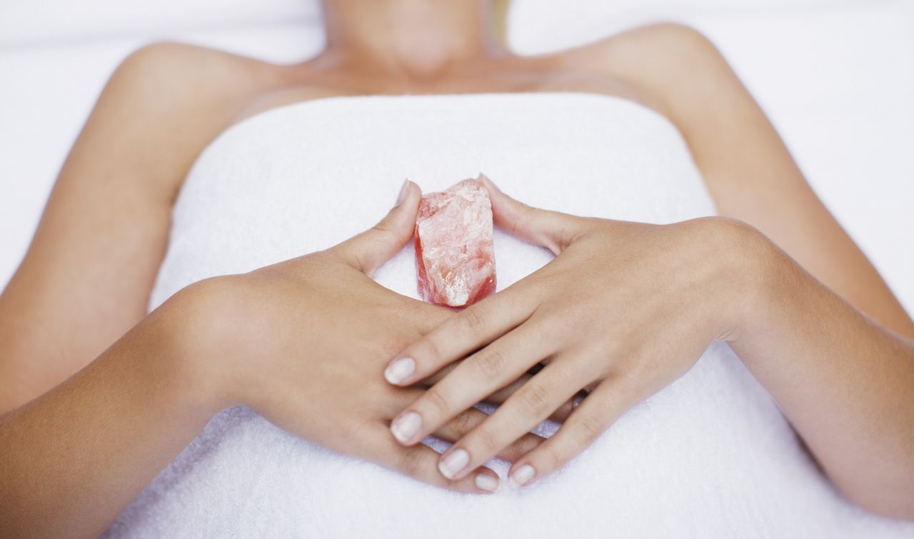 Woman laying with crystal, crystals to help sleep