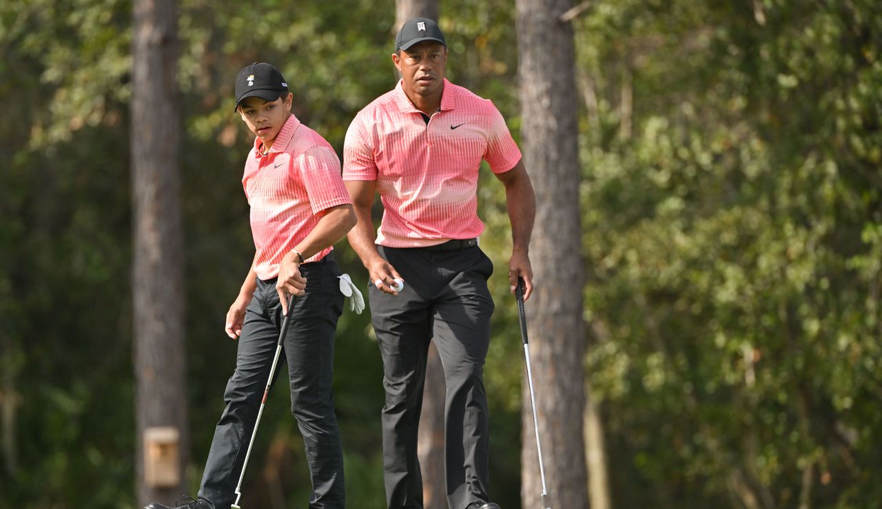 Charlie and Tiger line up a putt