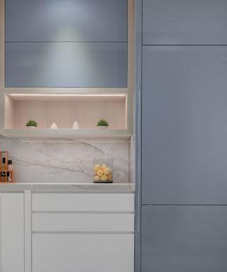 blue kitchen cabinetry with white worktop