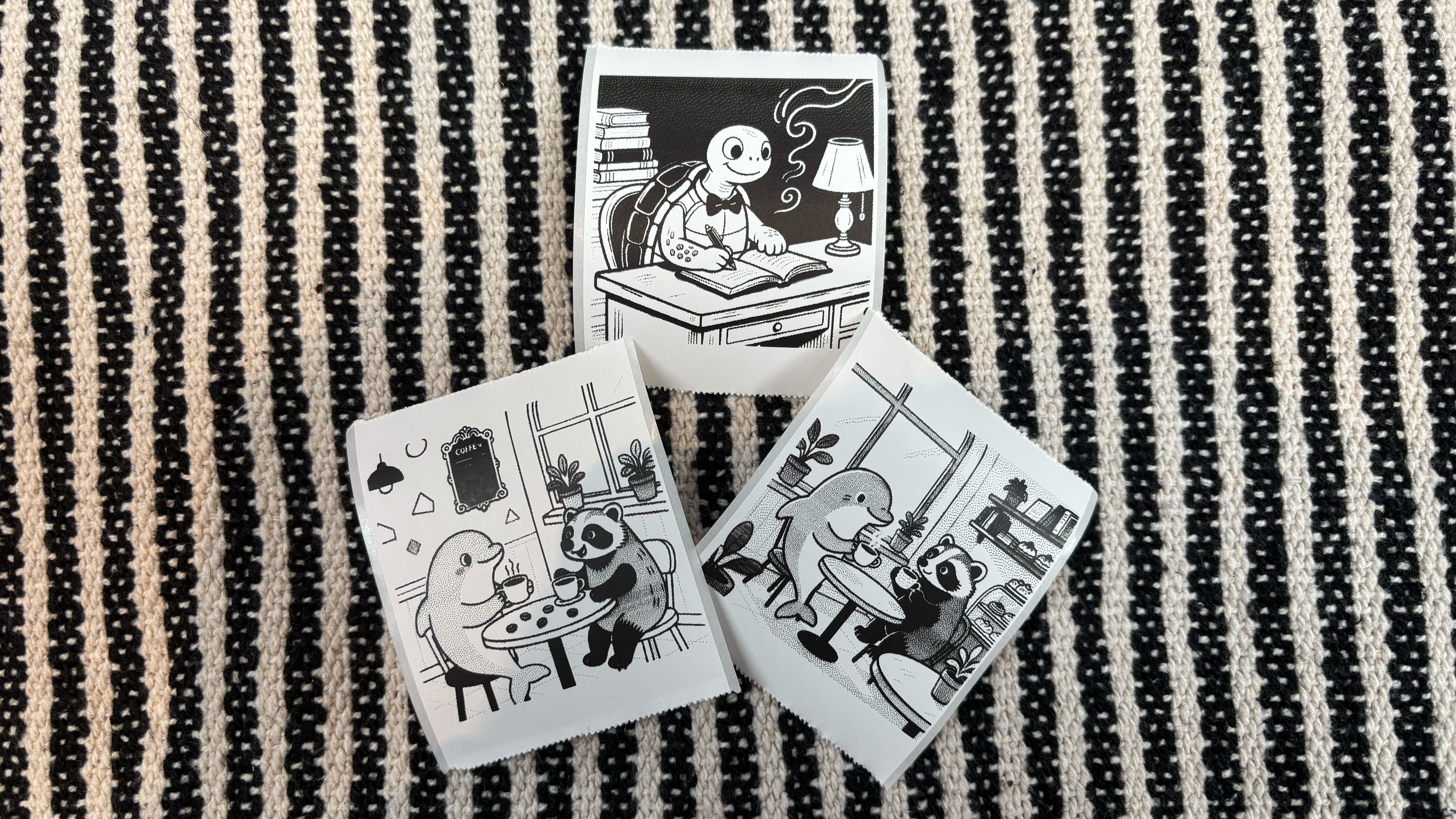 Custom sticker designs showing a badger and dolphin having coffee, and a turtle writing a novel