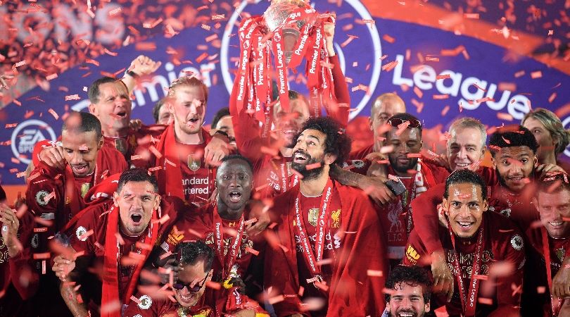 Liverpool players celebrate with the Premier League trophy at Anfield after a 5-3 win over Chelsea behind closed doors in July 2020, with fans not allowed inside the stadium due to the Covid-19 pandemic.