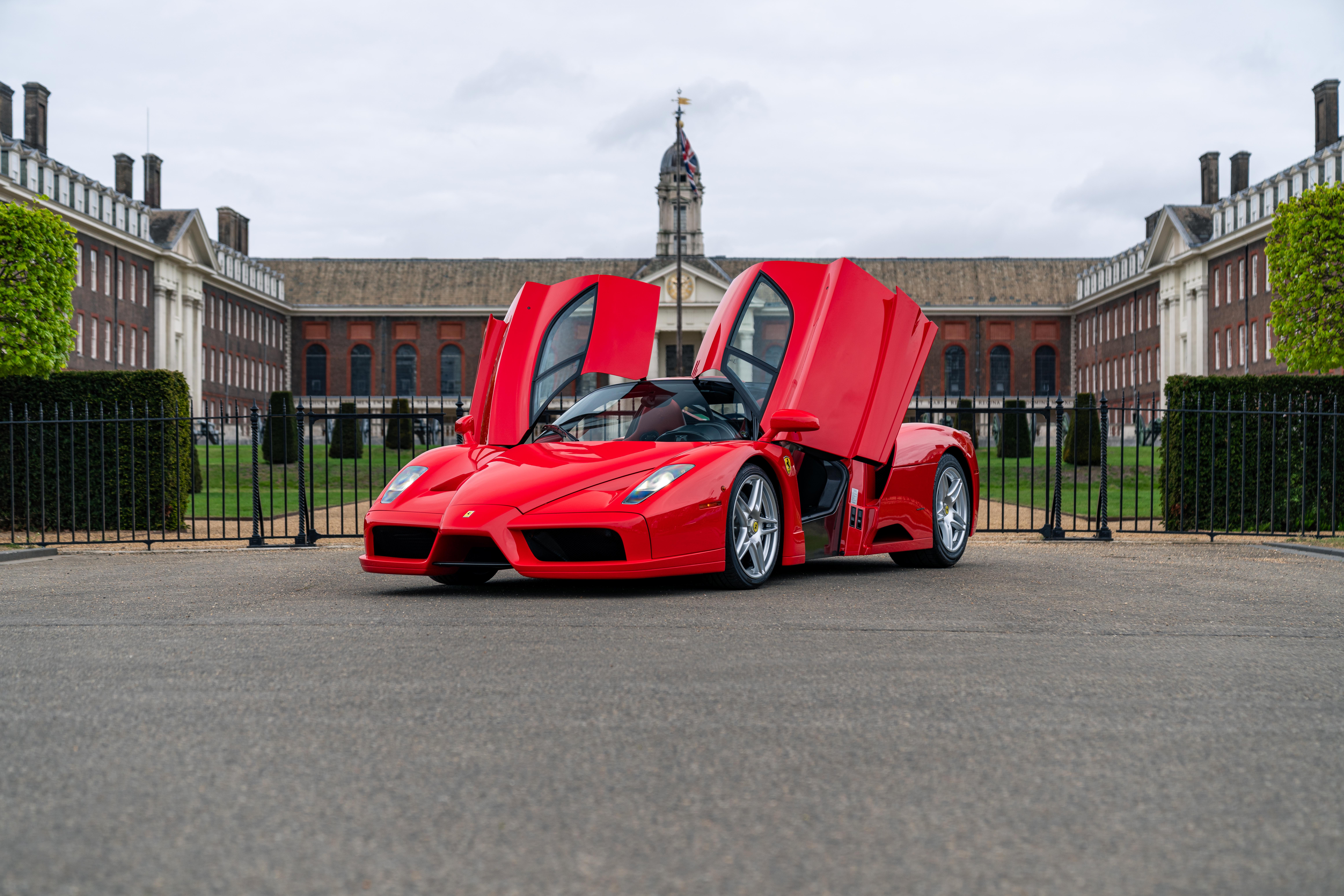 A Ferrari Enzo with its doors open in front of the RH Chelsea