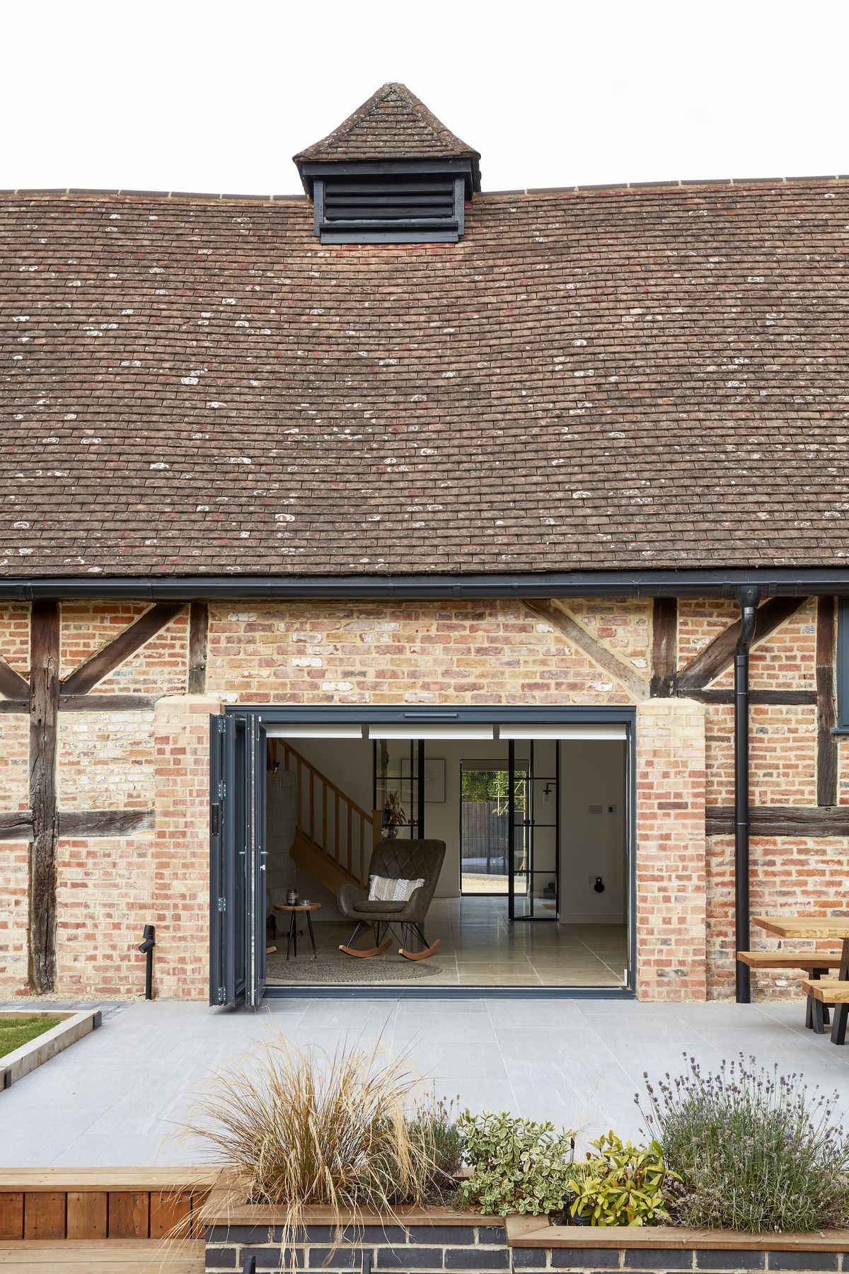 open bifold doors into brick barn conversion