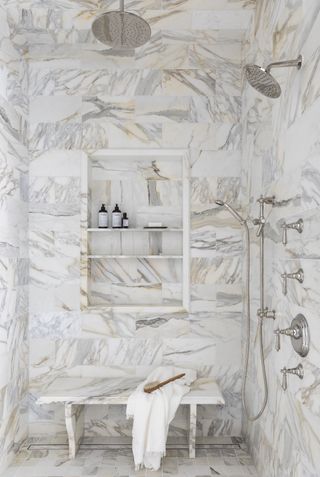 A shower area with a small storage niche