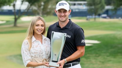 Patrick Cantlay and his partner Nikki hold a trophy