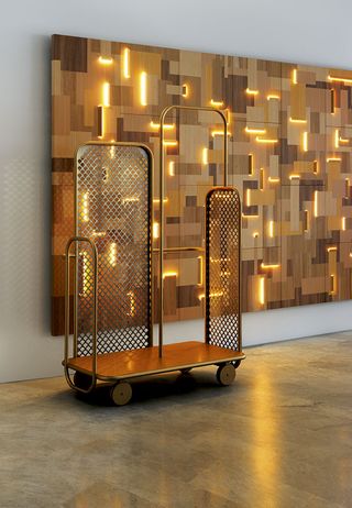 There’s a brass base for luggage, enclosed by side guards fashioned from tubular brass. Each guard frames a central aluminium mesh, laser-cut with an intricate pattern, while a tubular rail allows for the elegant hanging of clothes and accessories
