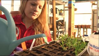 Michaela Musilova, a member of the mock Mars mission Crew 134, works with plants during an experiment at the Mars Desert Research Station habitat in January 2014.