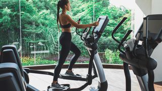a photo of a woman running on a cross trainer