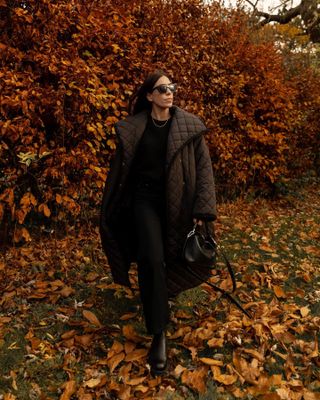 Woman wears quilted puffer coat and black boots