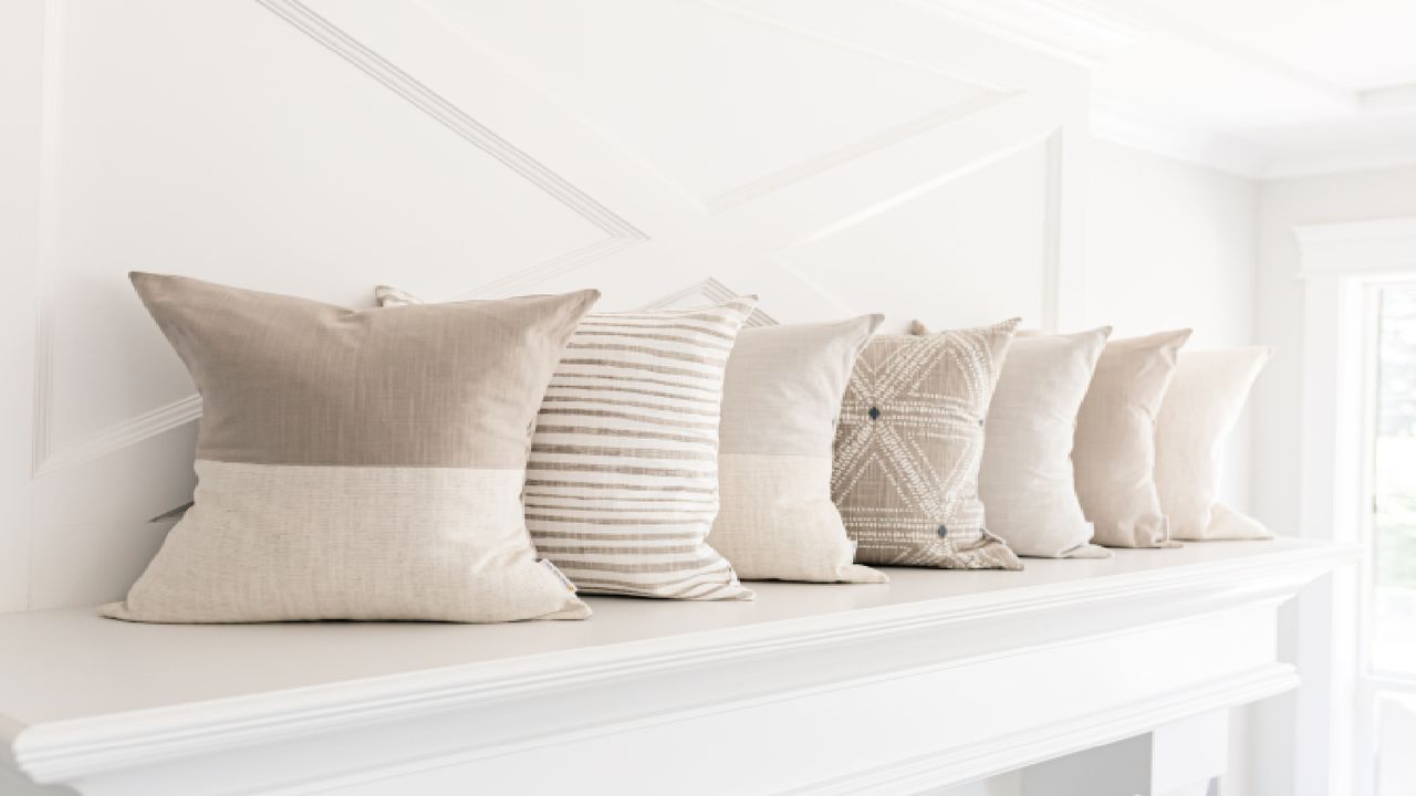 A series of cushions lined up against a wall