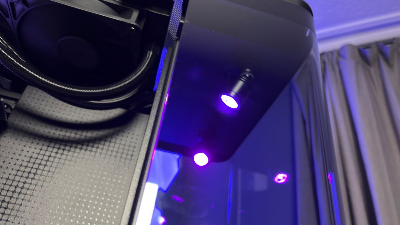 The CoolerMaster MasterFrame 360 Panoramic PC case with various components installed on a desk.