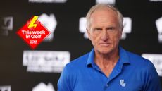 Greg Norman looks on with a stern expression while wearing a blue LIV Golf polo in 2025, with the This Week In Golf sticker (top left)