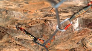 A climbing rope secured into bolts in the rock with quickdraws