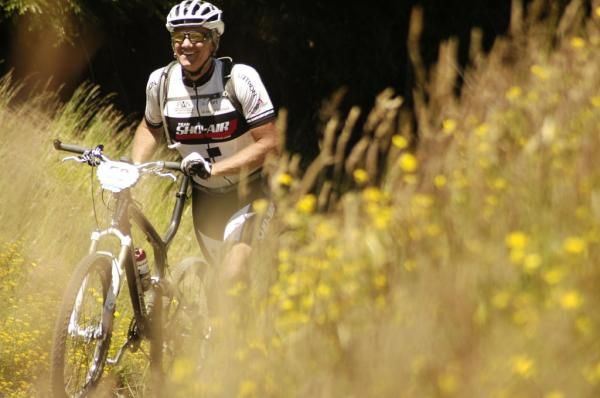 A racer walks with his bike in stage 3 of the Trans Andes.