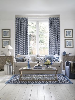 blue and white decor sitting room with white sofa and blue drapes