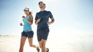 couple smiling and running in sunshine